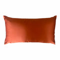 Orange satin cushion on a white background