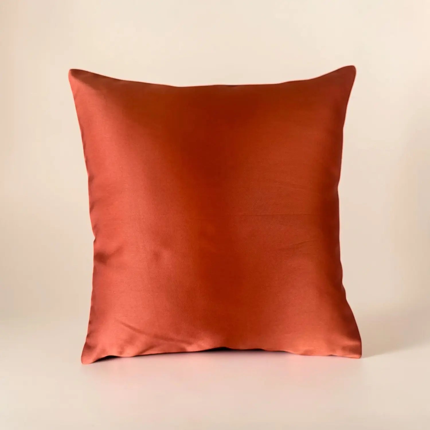 Orange cushion on a beige background