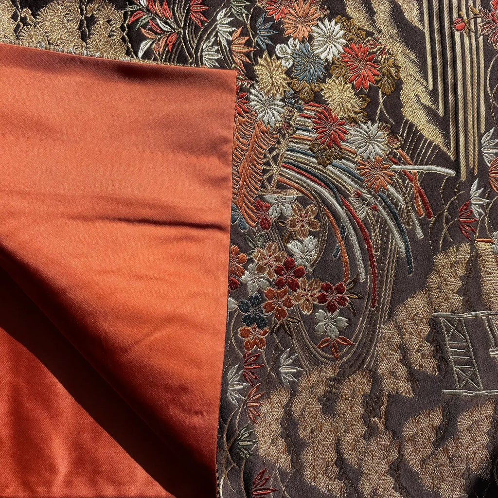 Close-up of embroidered fabric with floral patterns on a dark background