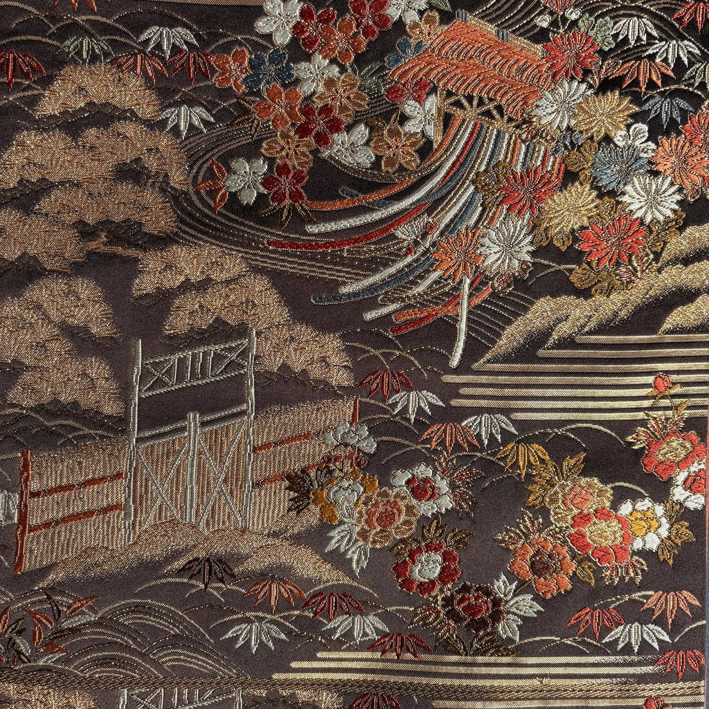 Embroidered fabric with floral patterns and architectural elements on a dark background