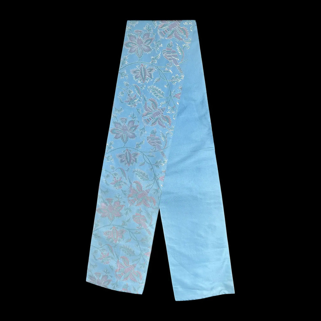 Light blue fabric with floral pattern on a black background