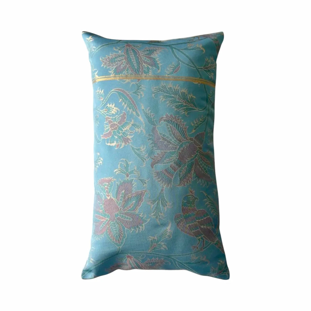 Decorative cushion with floral and bird pattern on a white background