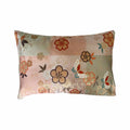 Floral and butterfly patterned cushion on a white background