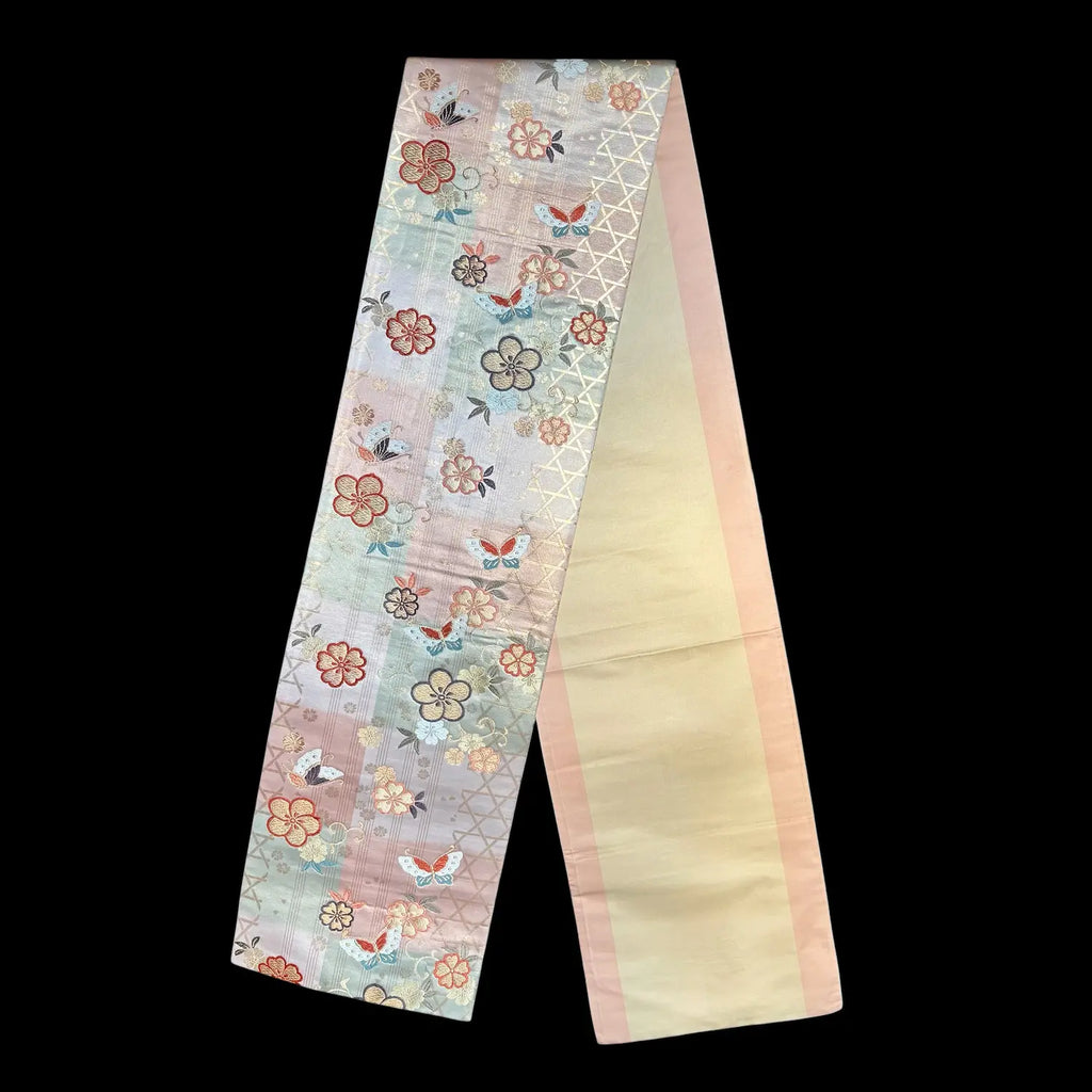 Decorative runner strip with floral and butterfly patterns on a black background