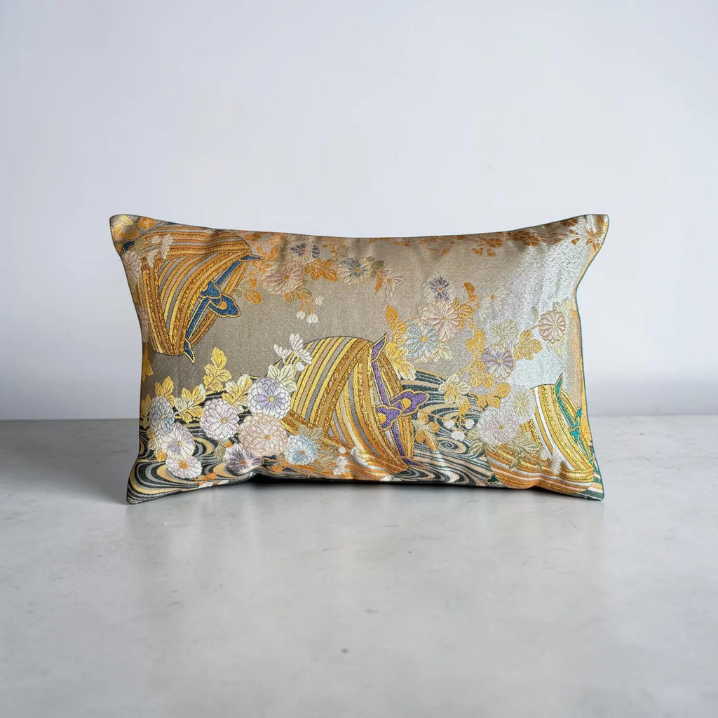 Decorative cushion with floral and abstract patterns on a plain background