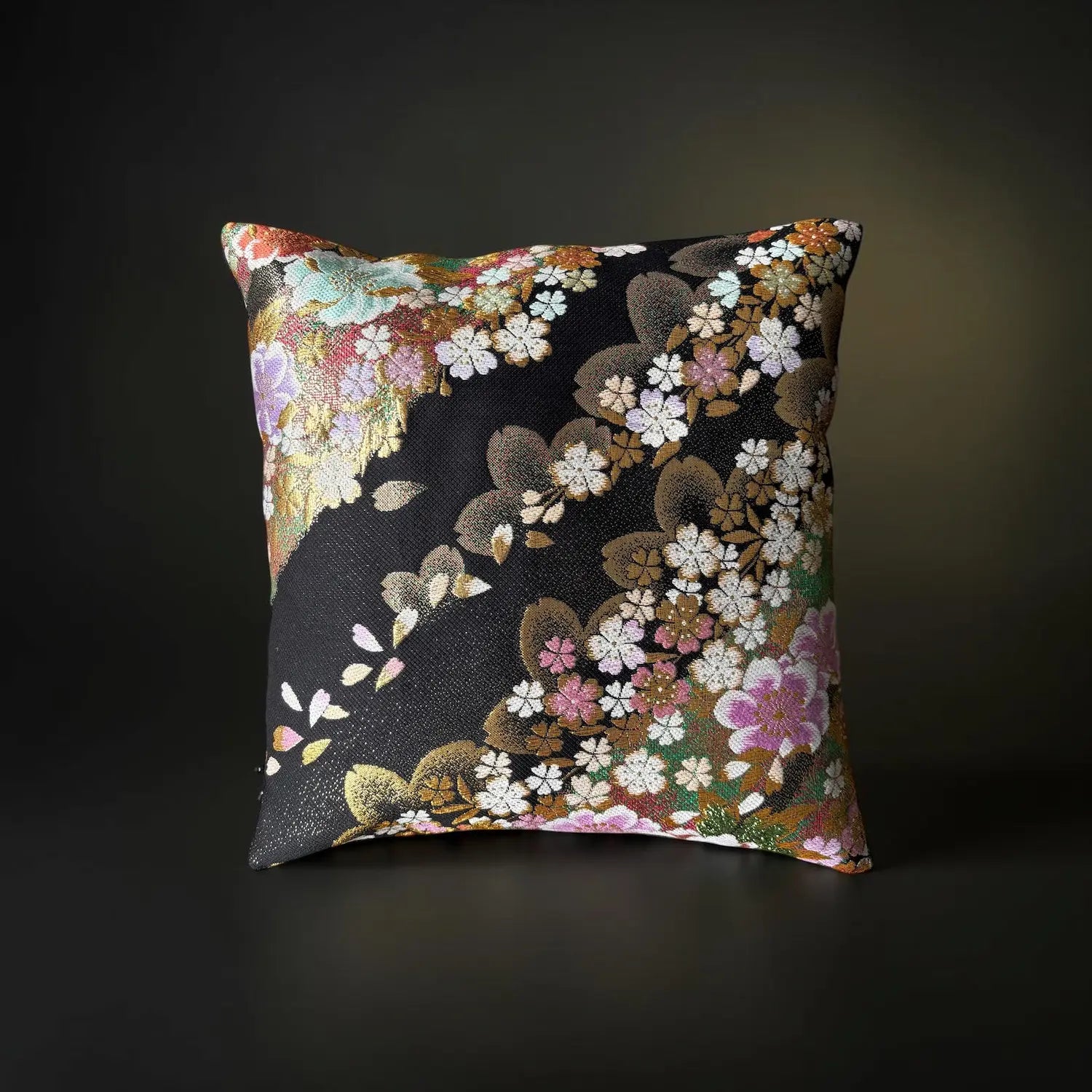 Decorative cushion with floral pattern on a dark background