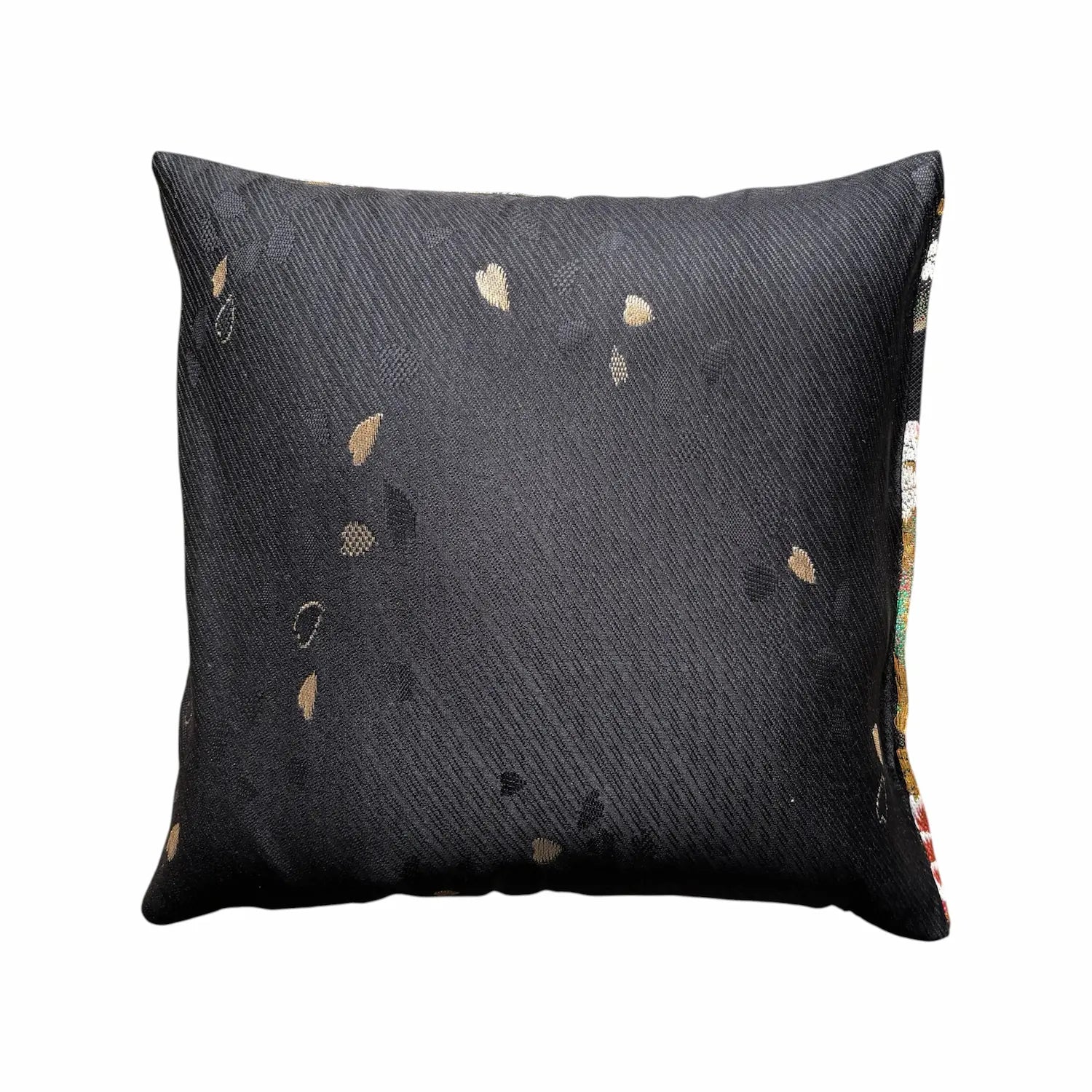 Black pillow with gold speckles on a white background