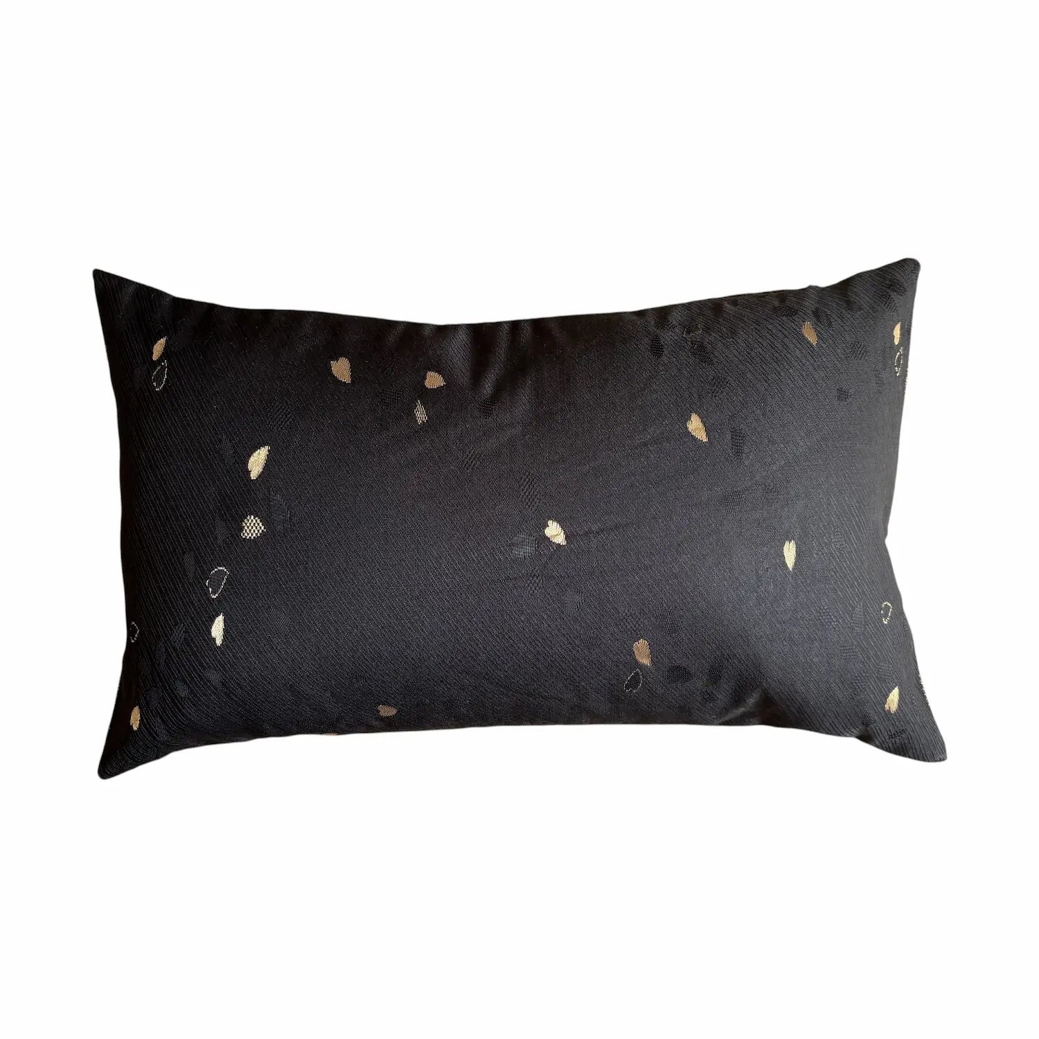 Black cushion with gold embroidery on a white background