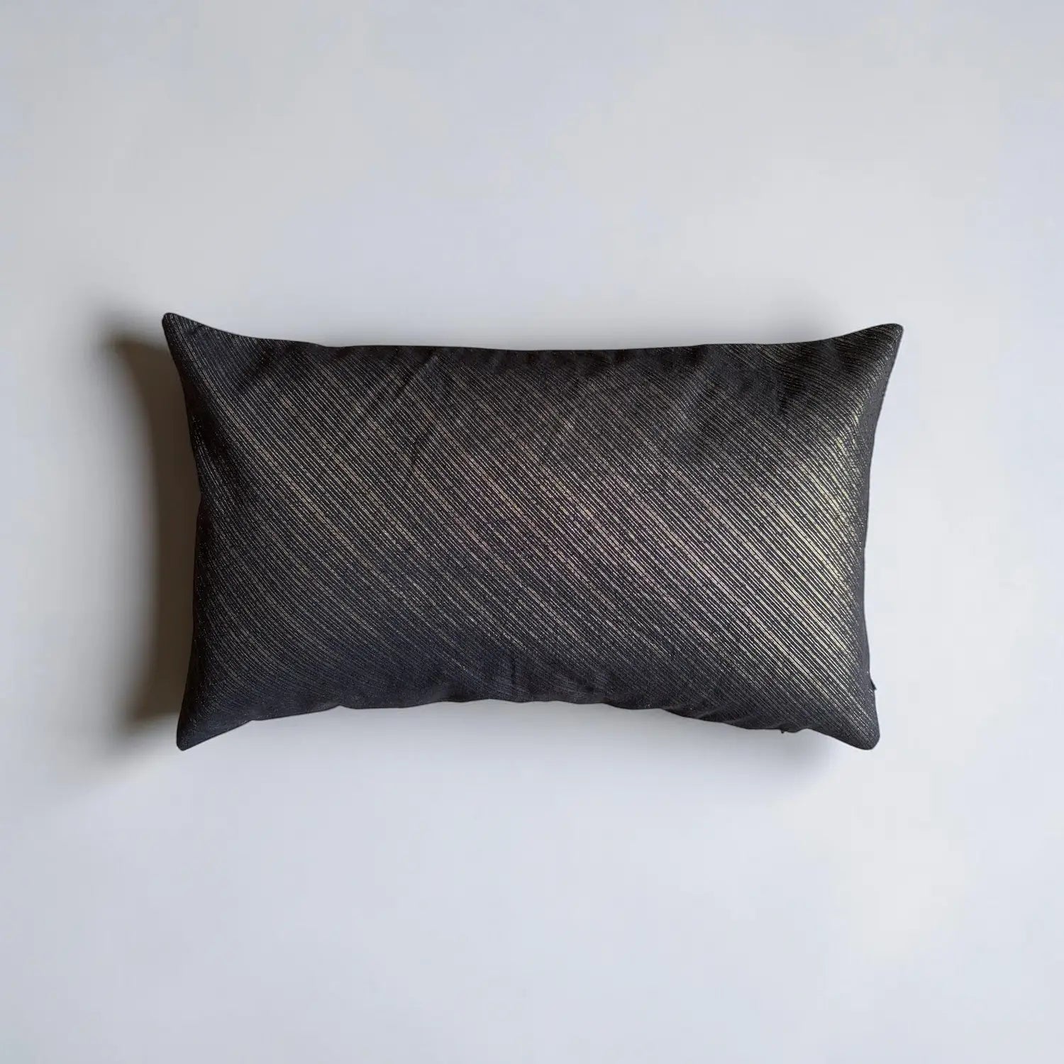 Textured black cushion on a white background