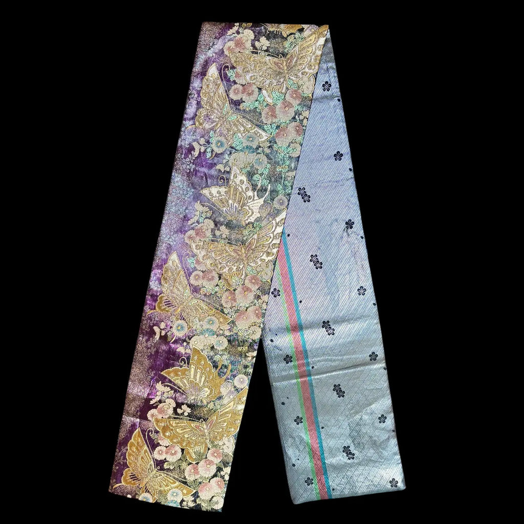 A fabric strip with butterfly patterns on a black background
