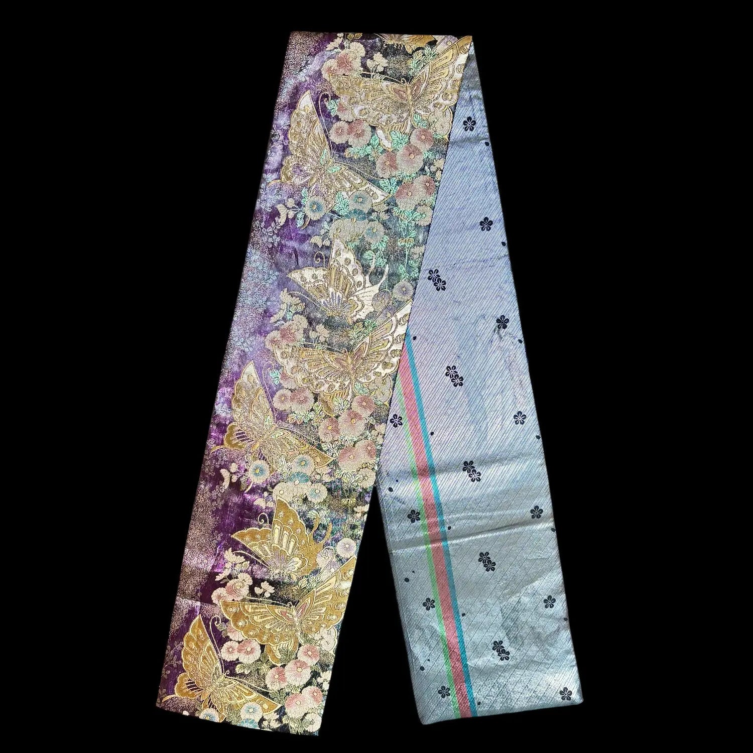 A fabric strip with butterfly patterns on a black background
