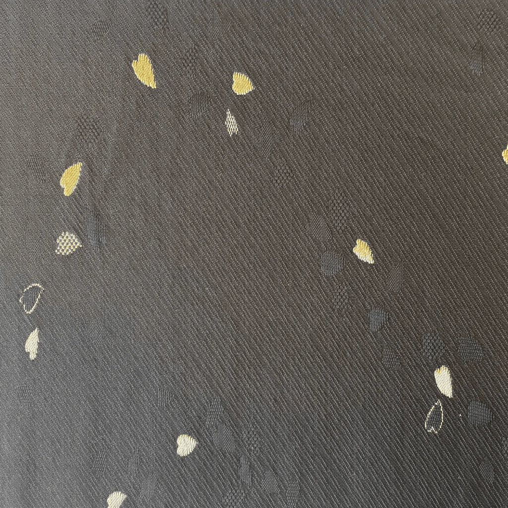 Black fabric with small embroidered floral patterns