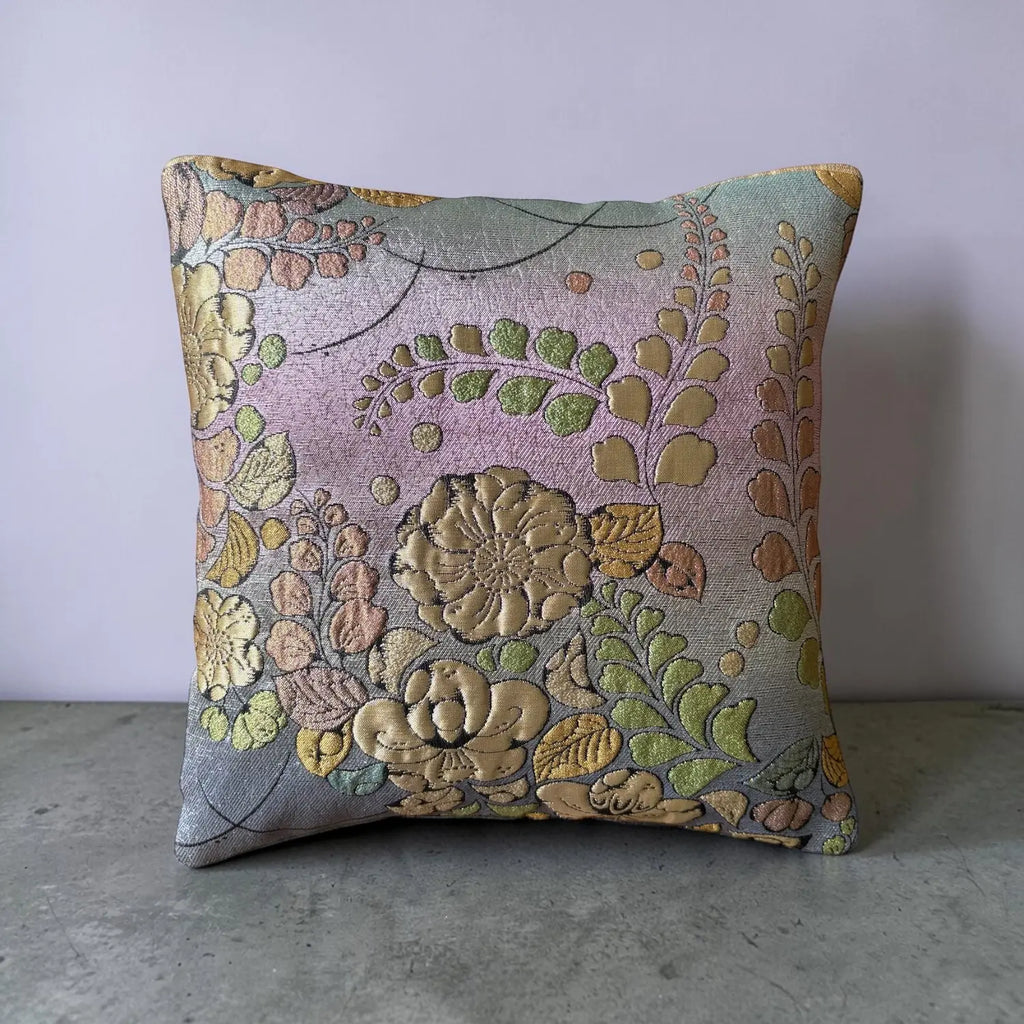 Decorative cushion with floral pattern on a plain background
