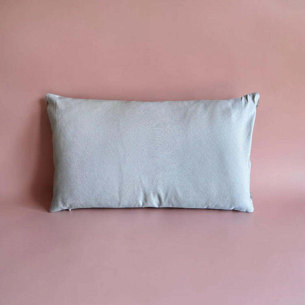 Gray pillow on a pink background