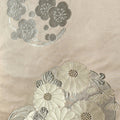 Close-up of embroidered floral patterns on a fabric background