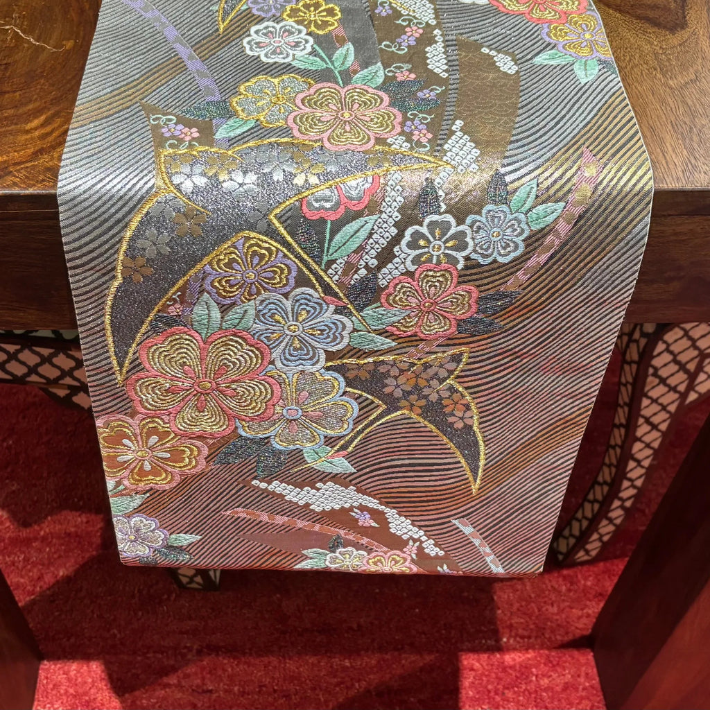 Decorative table runner with floral pattern on a wooden surface