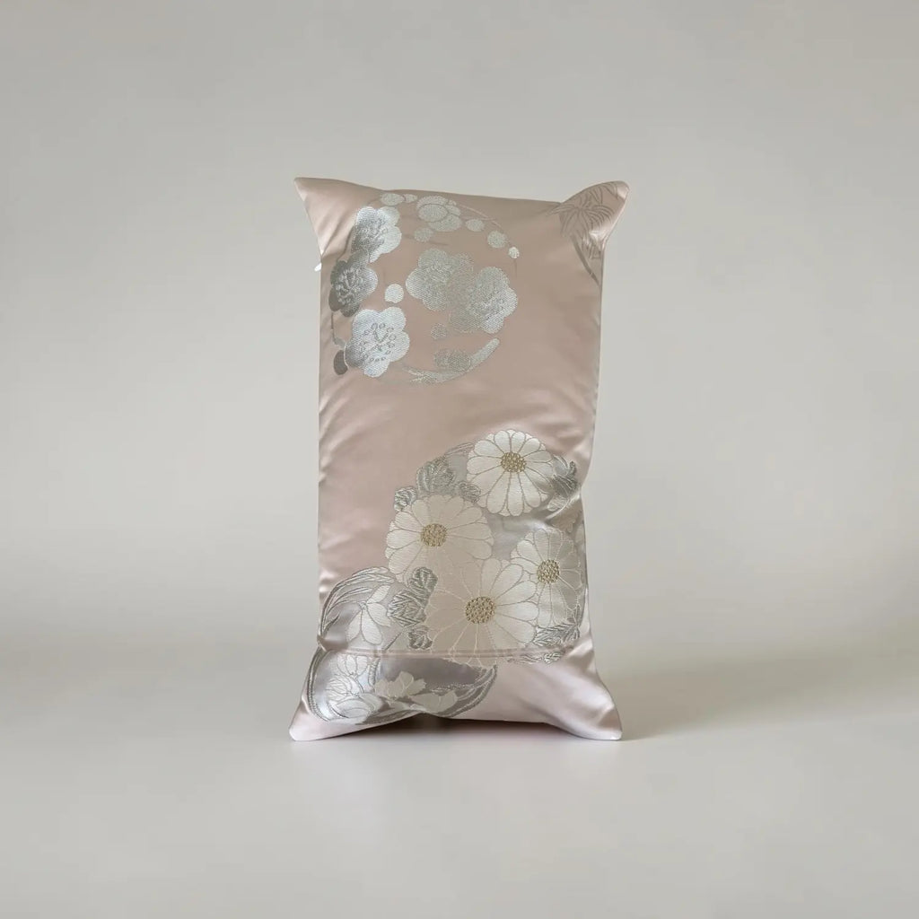 Decorative cushion with floral pattern on a plain background