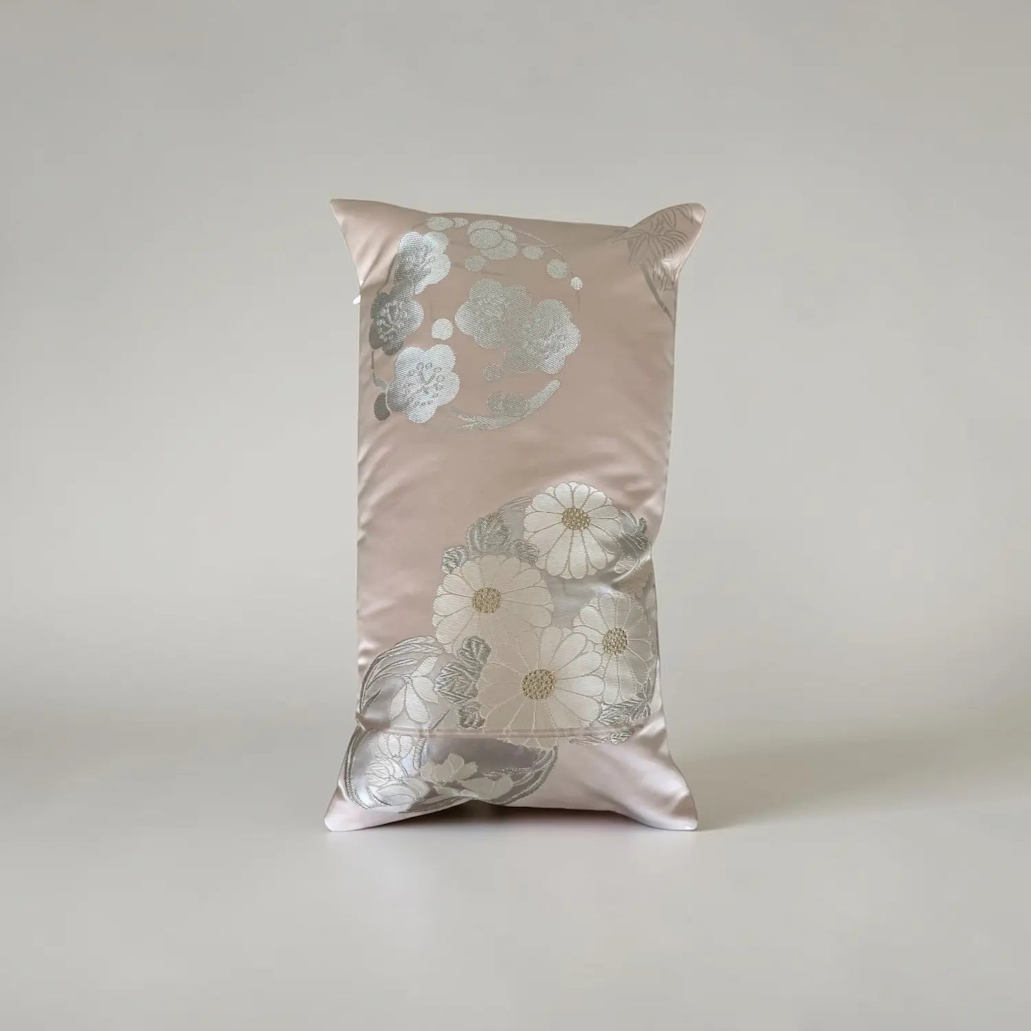 Decorative cushion with floral pattern on a plain background