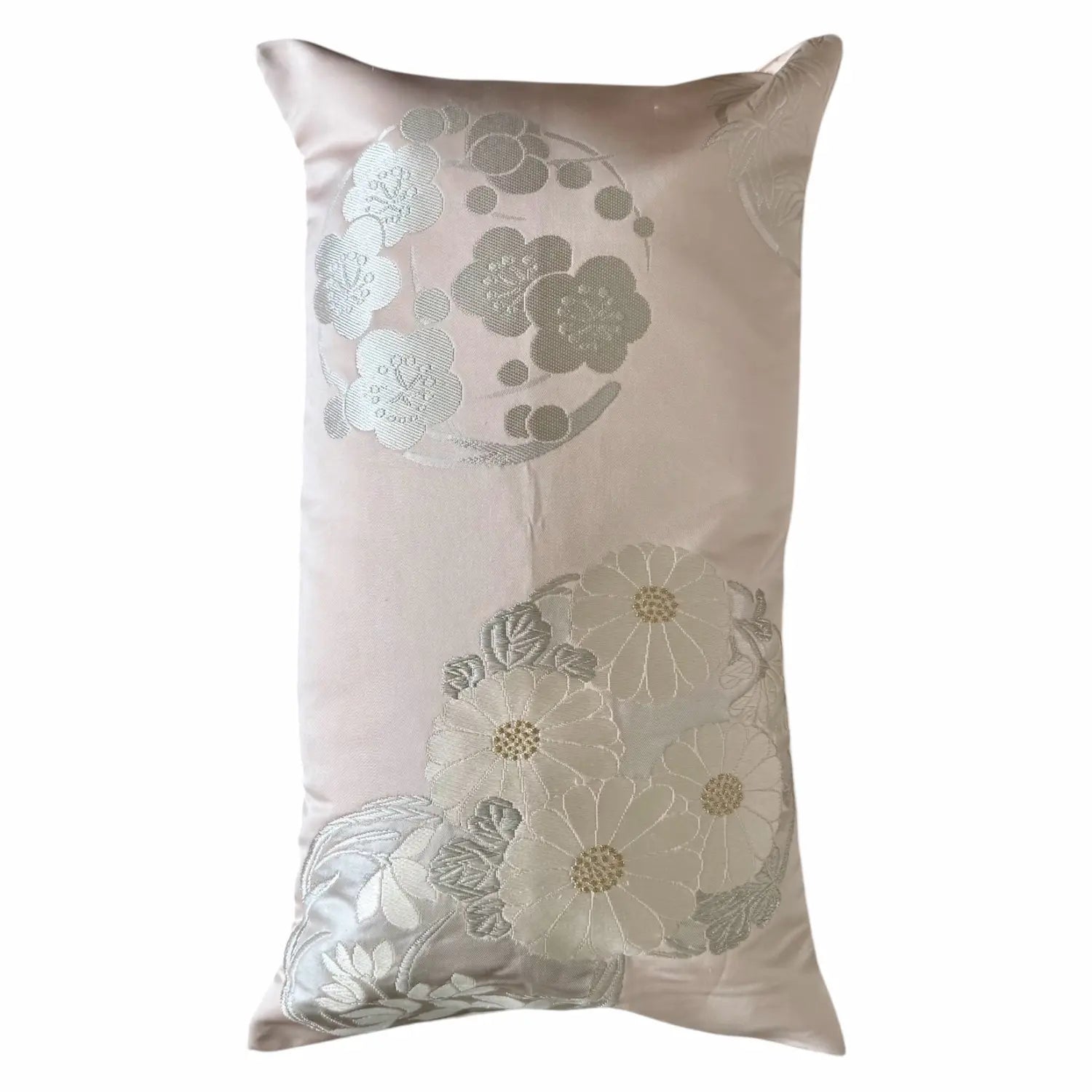 Decorative cushion with floral patterns on a light pink background