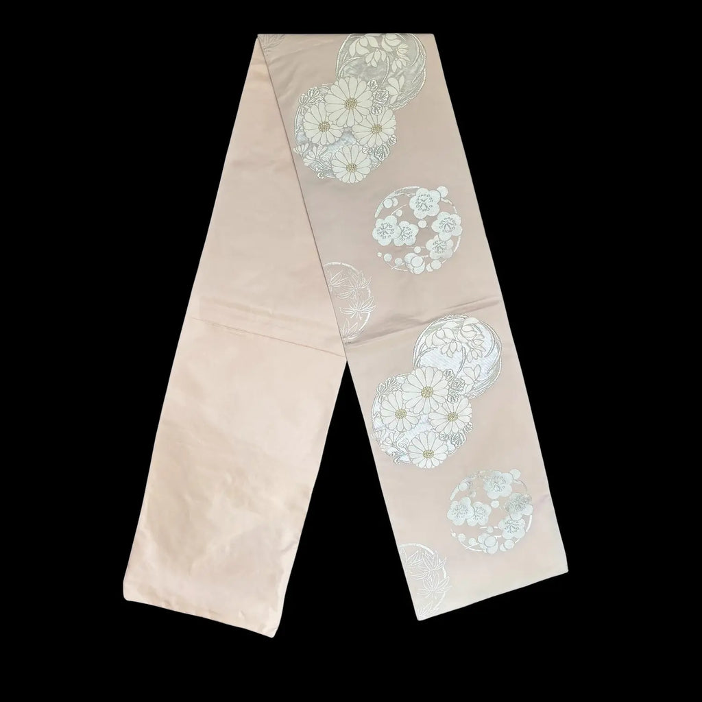 Pink textile with floral embroidery on a black background