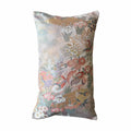 Decorative cushion with floral and bird pattern on a white background