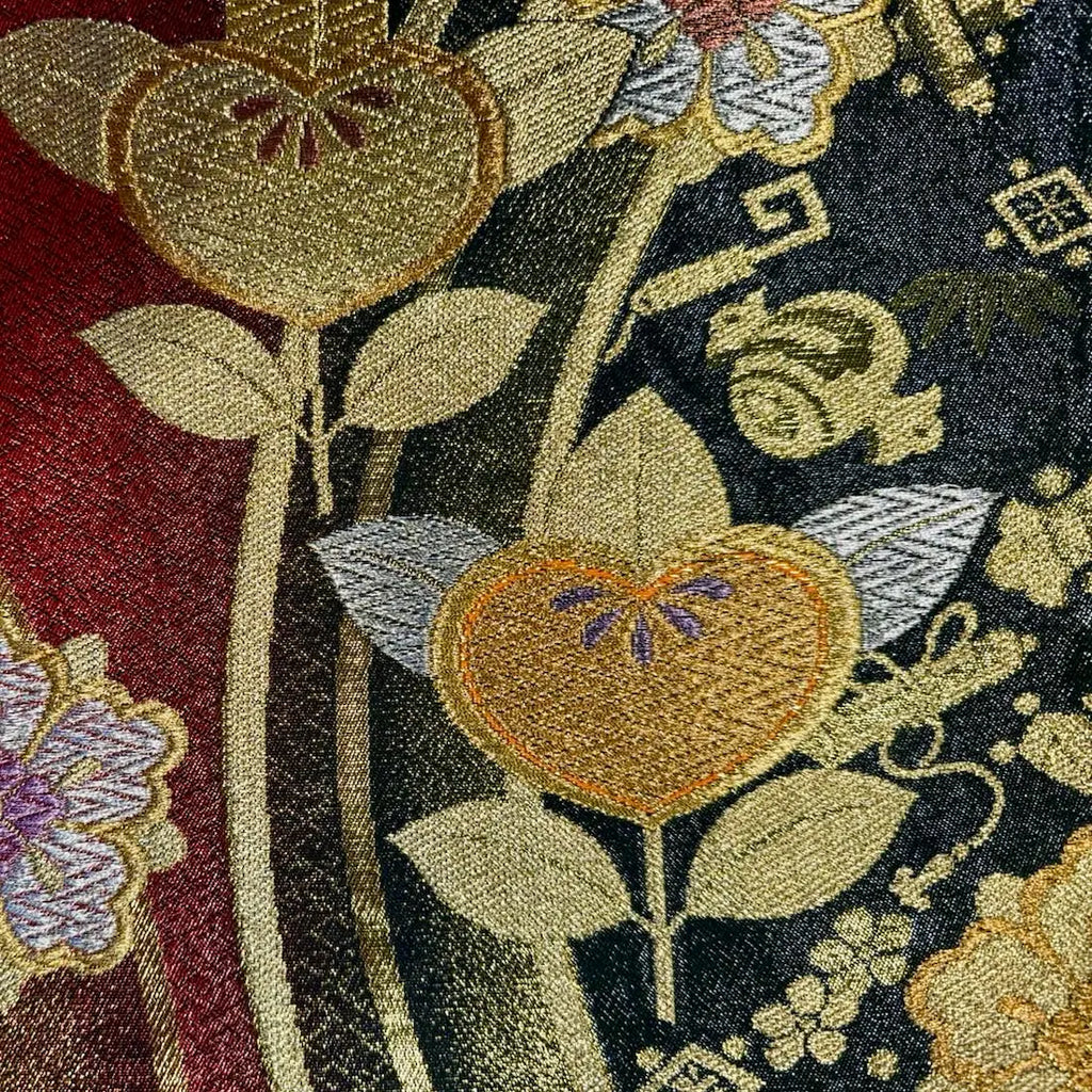 Close-up of embroidered floral pattern with leaves on a fabric background