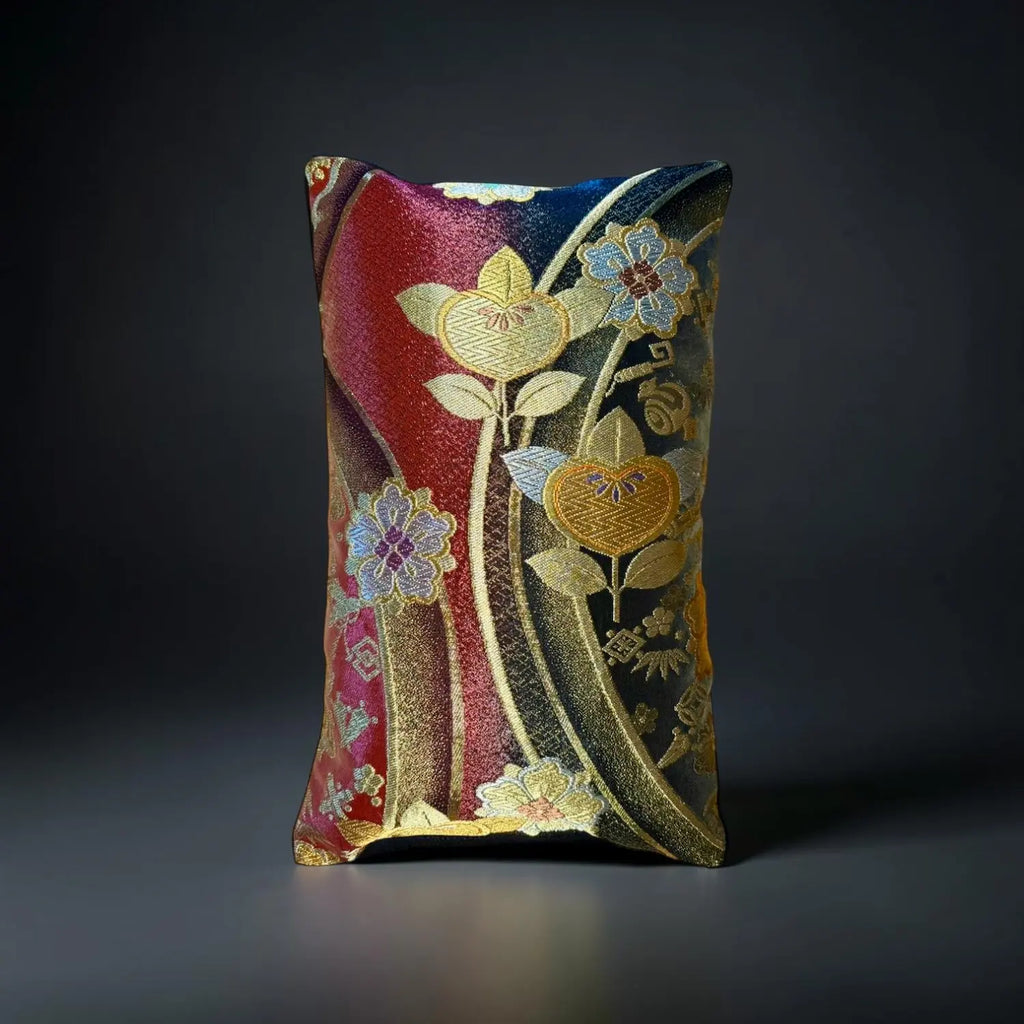 Decorative cushion with floral patterns on a dark background