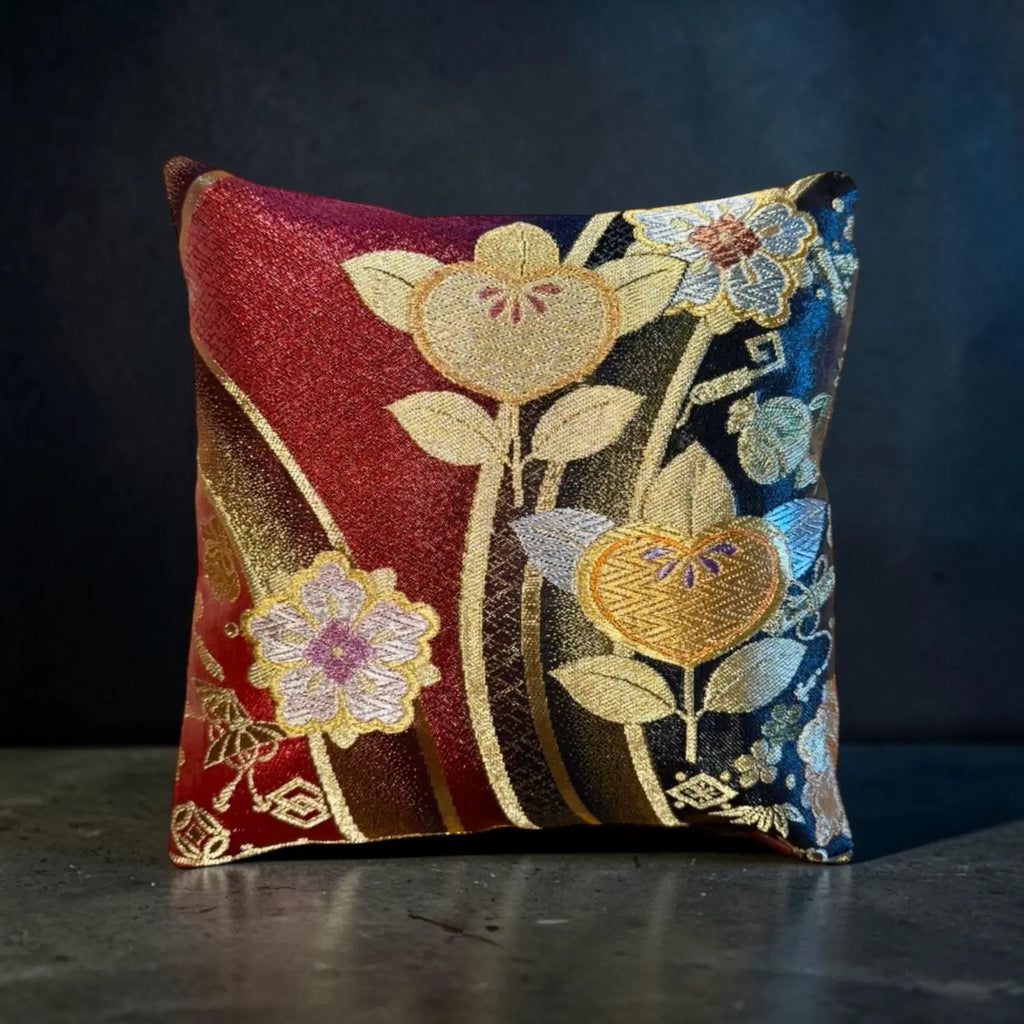 Decorative cushion with floral embroidery on a dark background
