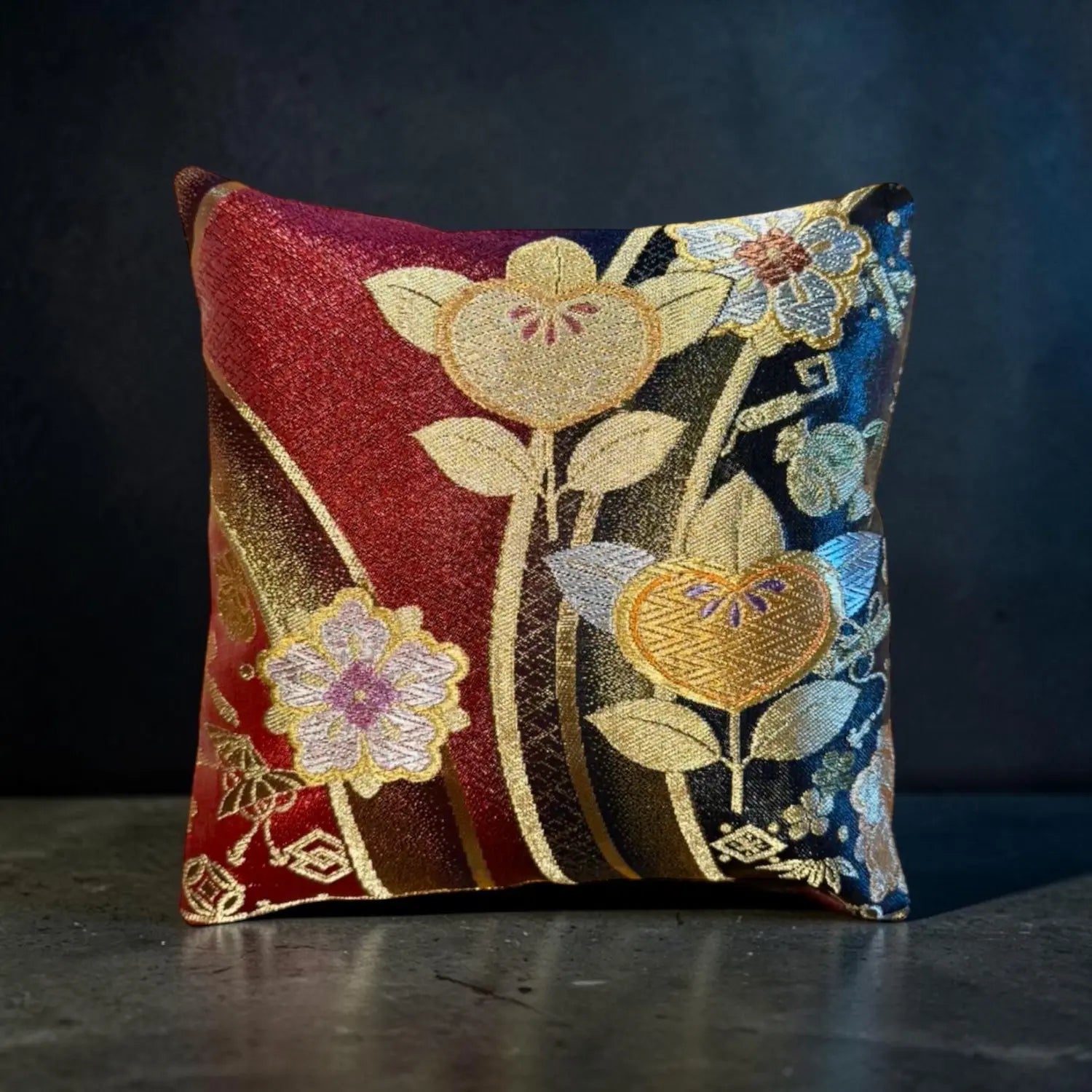 Decorative cushion with floral embroidery on a dark background