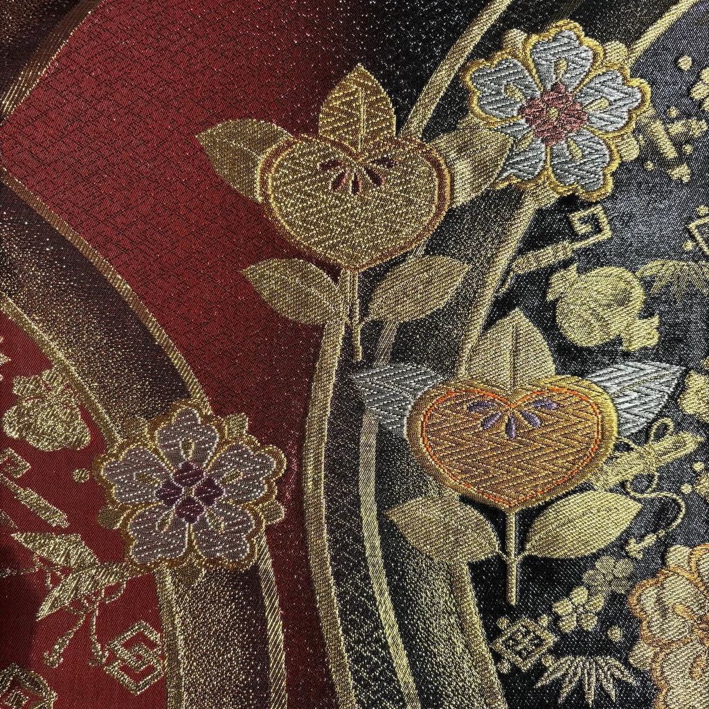 Close-up of embroidered floral patterns on fabric with a dark background