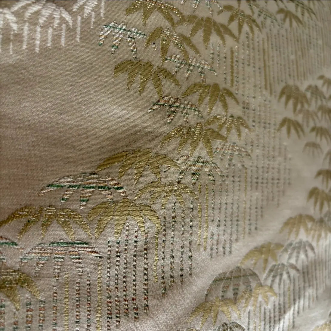 Textile with bamboo and deer design on a beige background