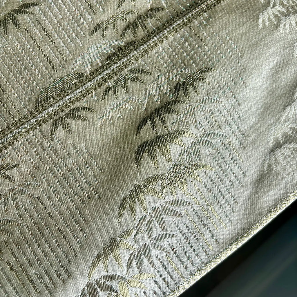Close-up of a fabric with a bamboo pattern on a gold background