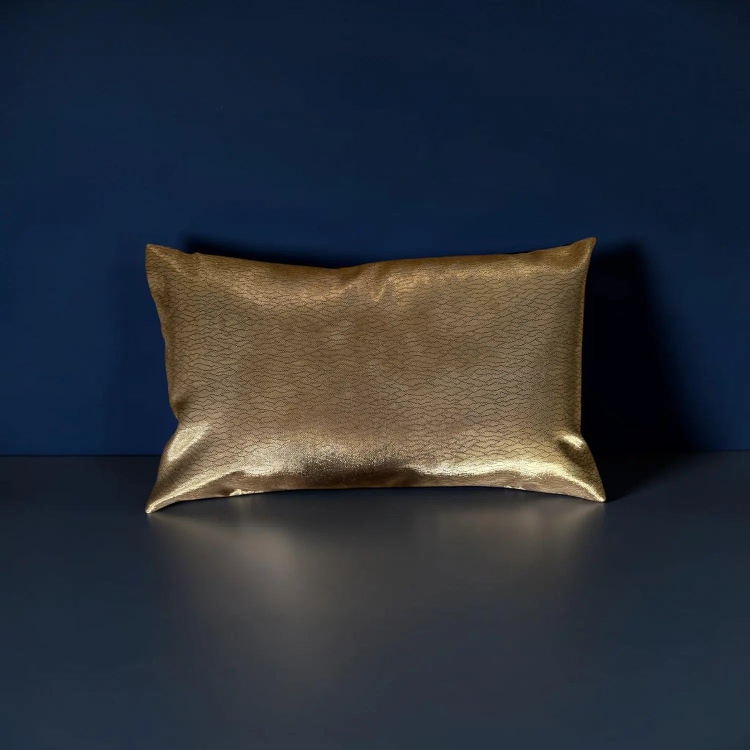 Gold cushion on a dark blue background