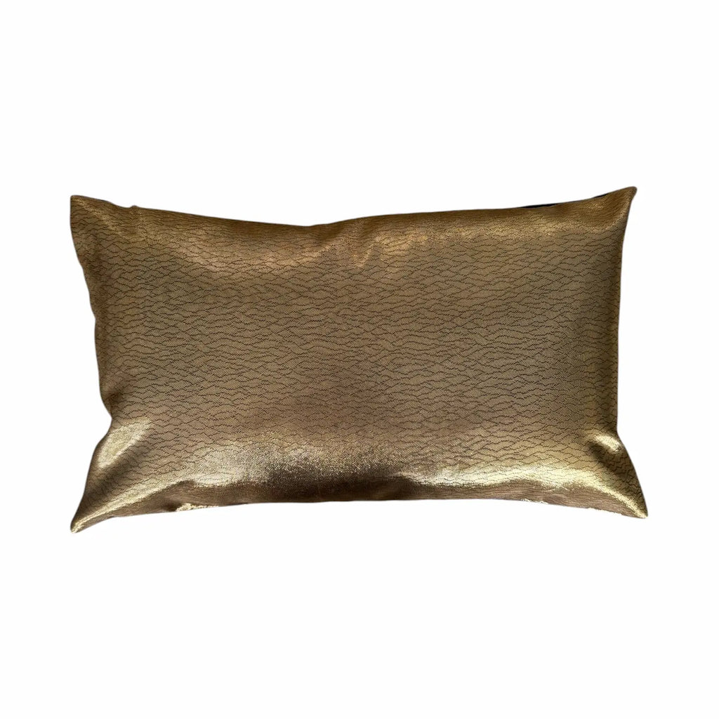Gold metallic cushion on a white background