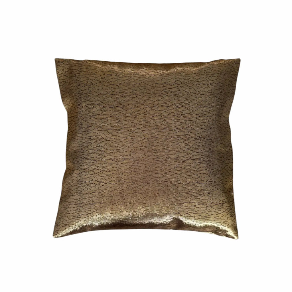 Gold metallic cushion on a white background