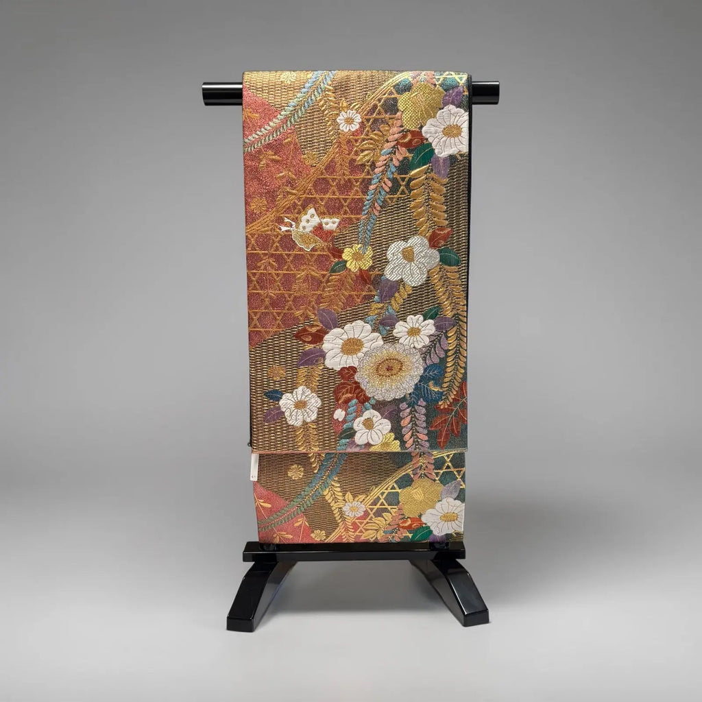 Decorative fabric with floral patterns on a stand against a gray background