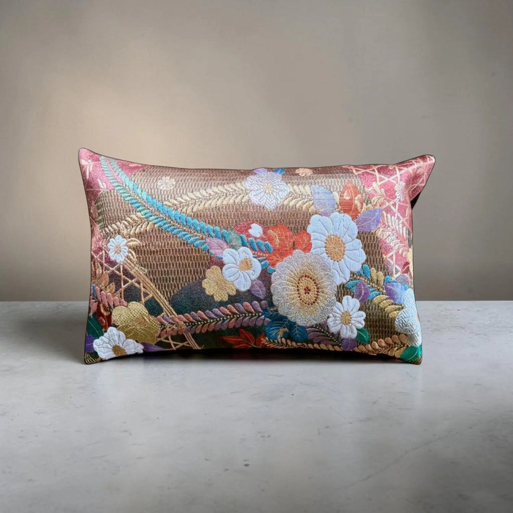 Decorative cushion with floral patterns on a neutral background