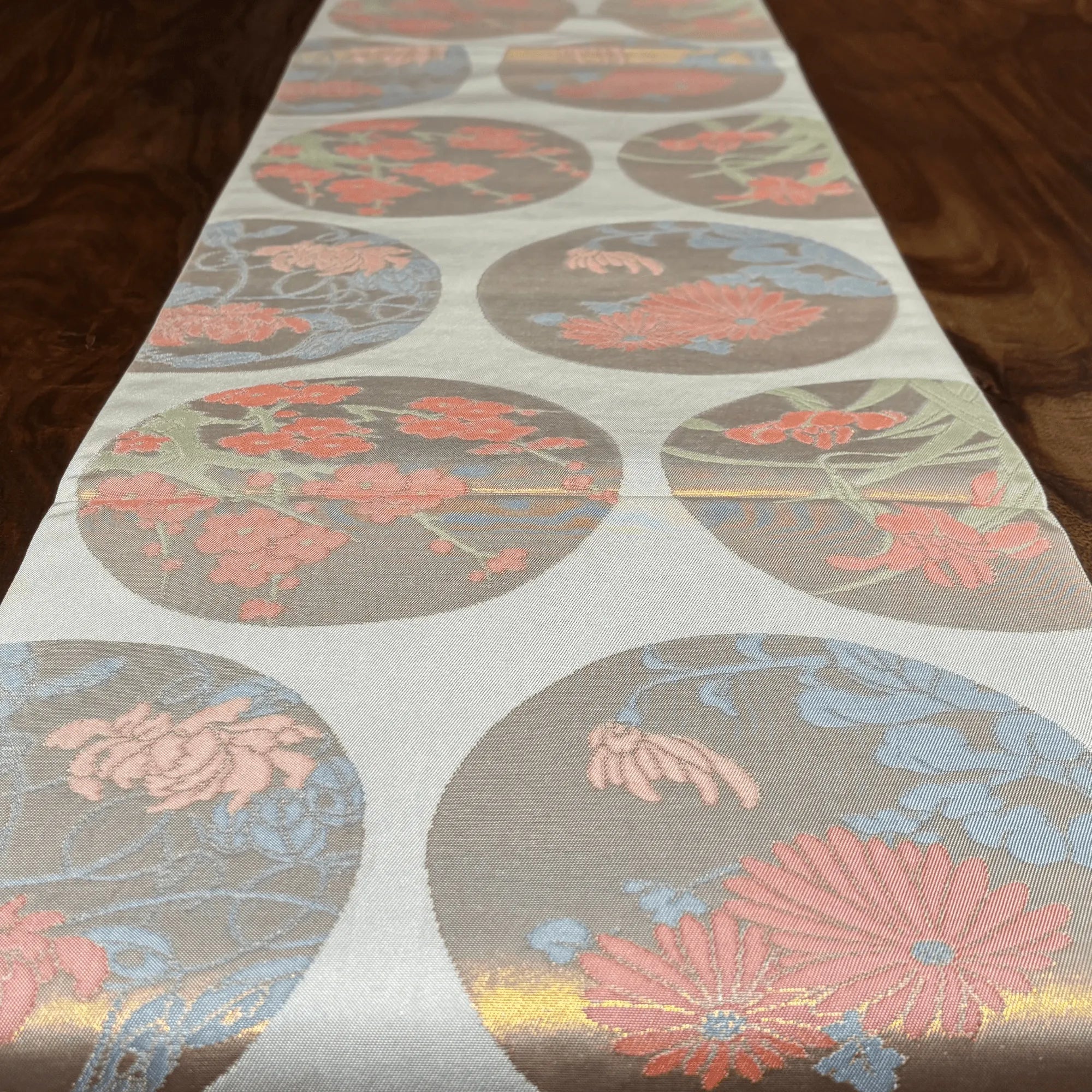 Floral patterned table runner on a wooden surface