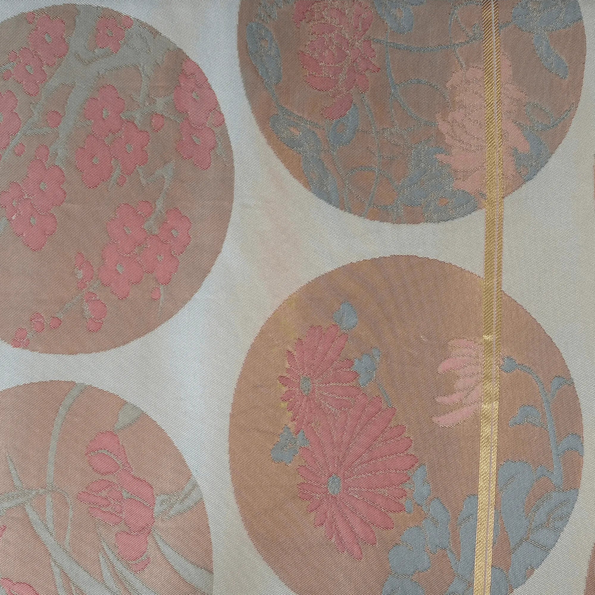 Decorative silk runner with floral patterns in pink and brown on a beige background