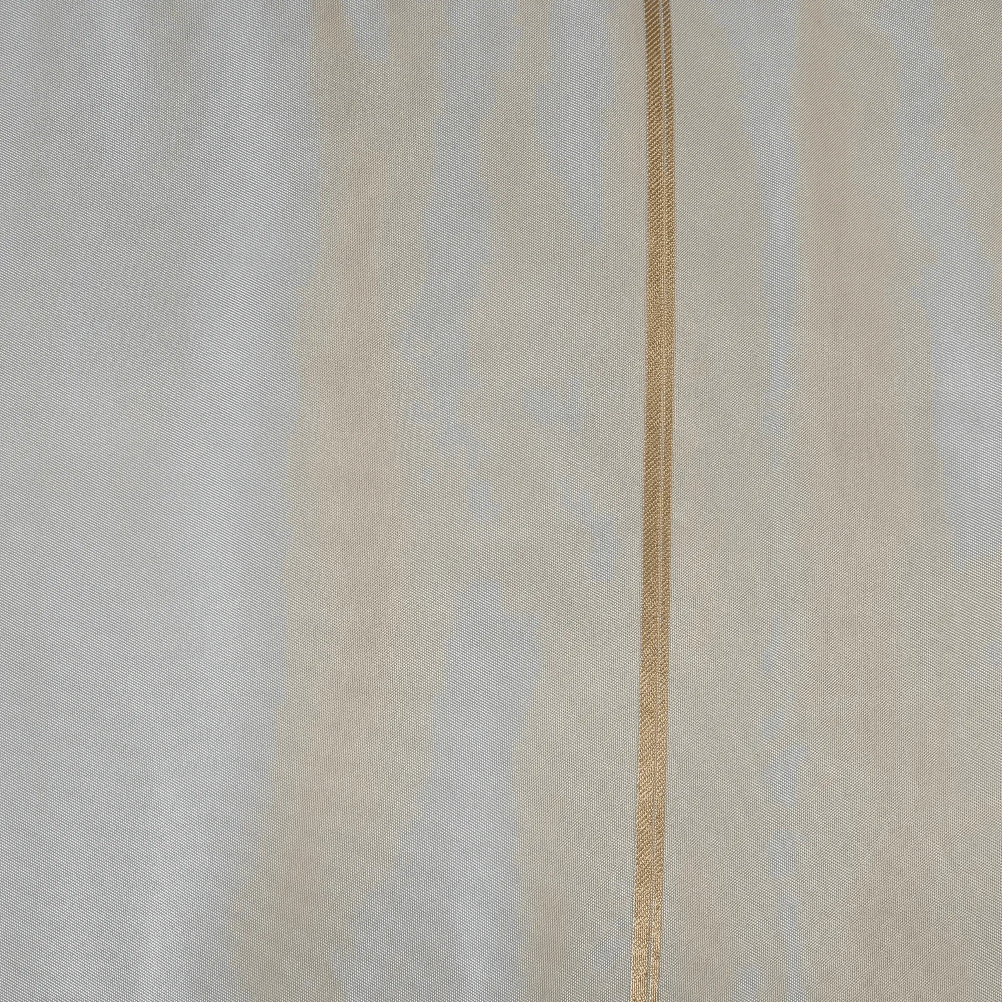 Close-up of silk fabric with a thin gold line.