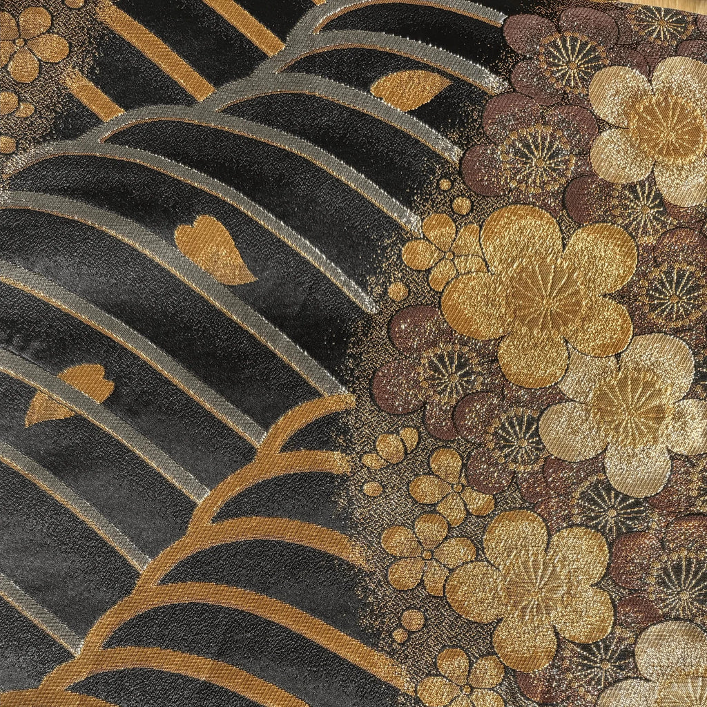 Decorative pattern with gold flowers and leaves on a black background