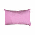 Pink cushion with a subtle pattern on a white background