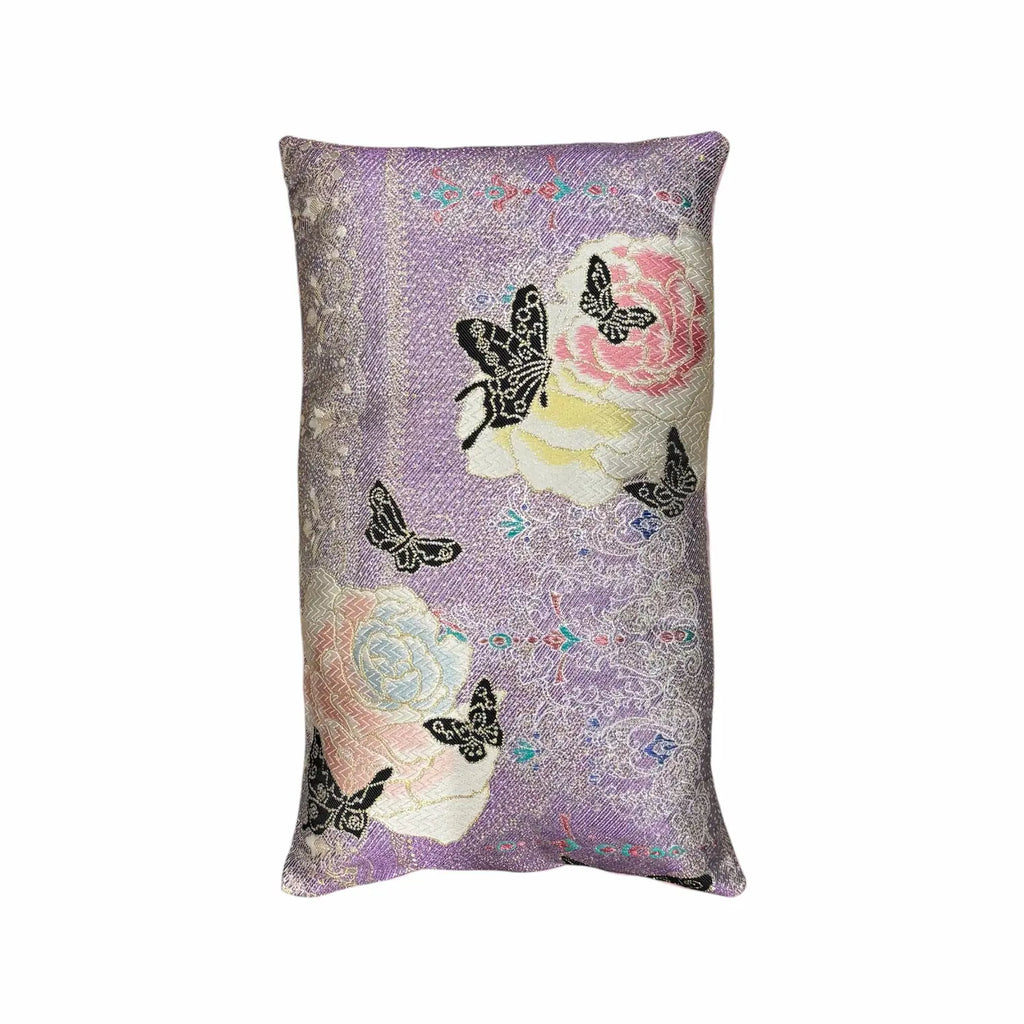 Decorative cushion with floral and butterfly patterns on a white background