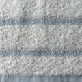 Close-up of textured fabric with horizontal stripes in blue and white.