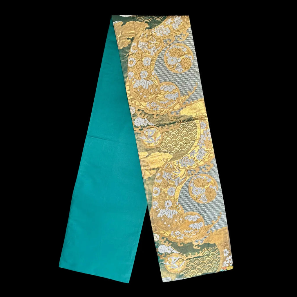 Decorative fabric strip with gold and white patterns on a black background