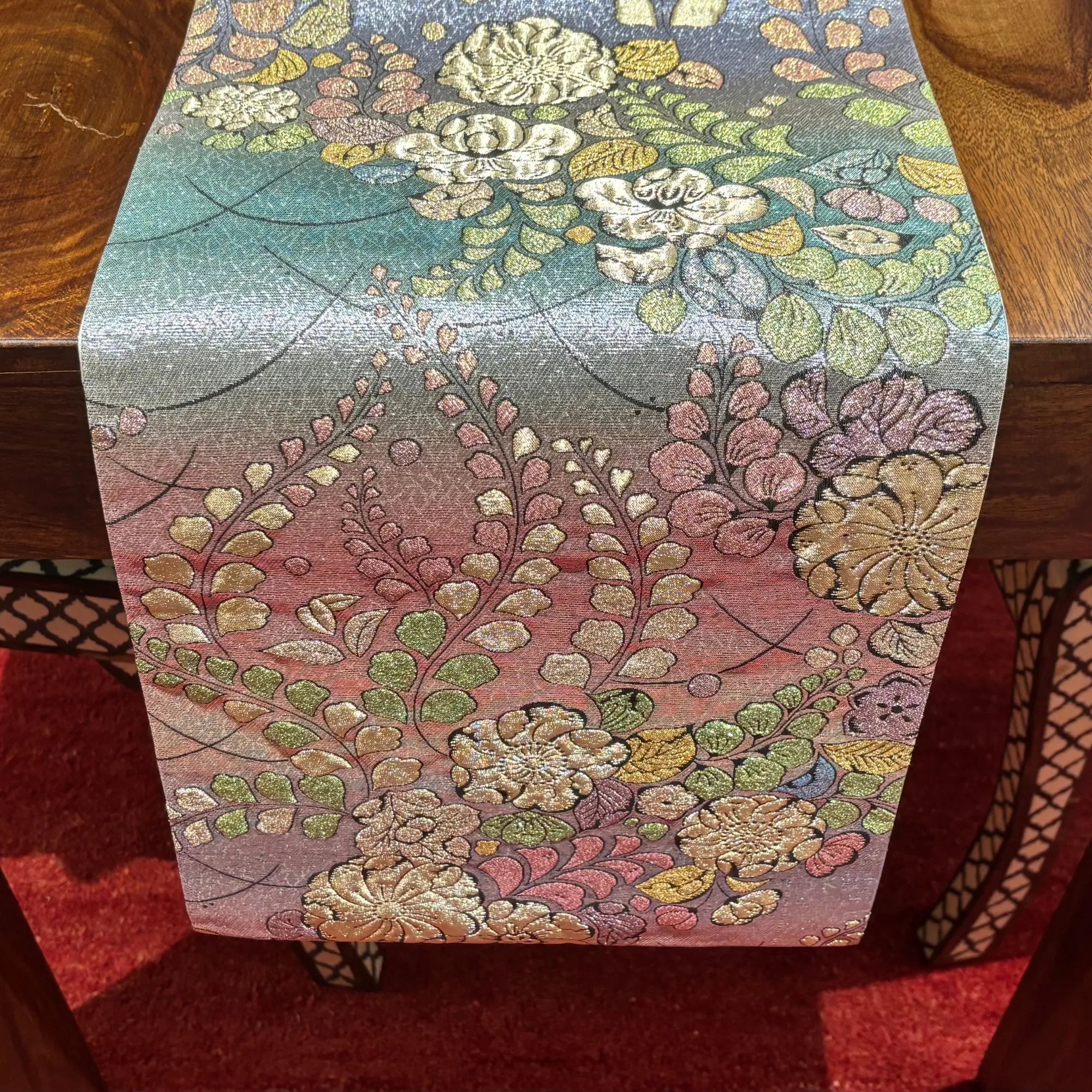 Floral patterned table runner on a wooden surface