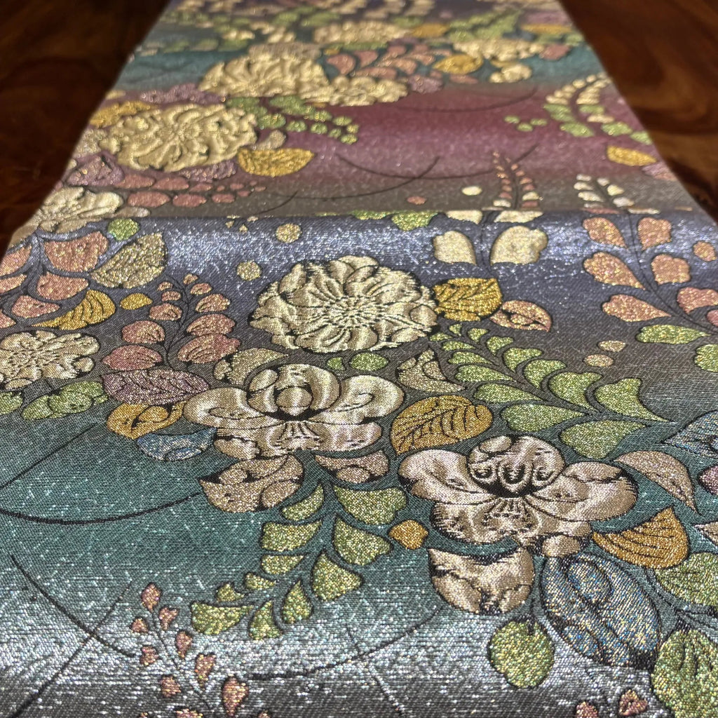 Floral patterned fabric with intricate designs on a wooden surface