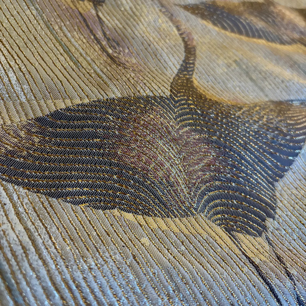 Close-up of a textured fabric with crane pattern