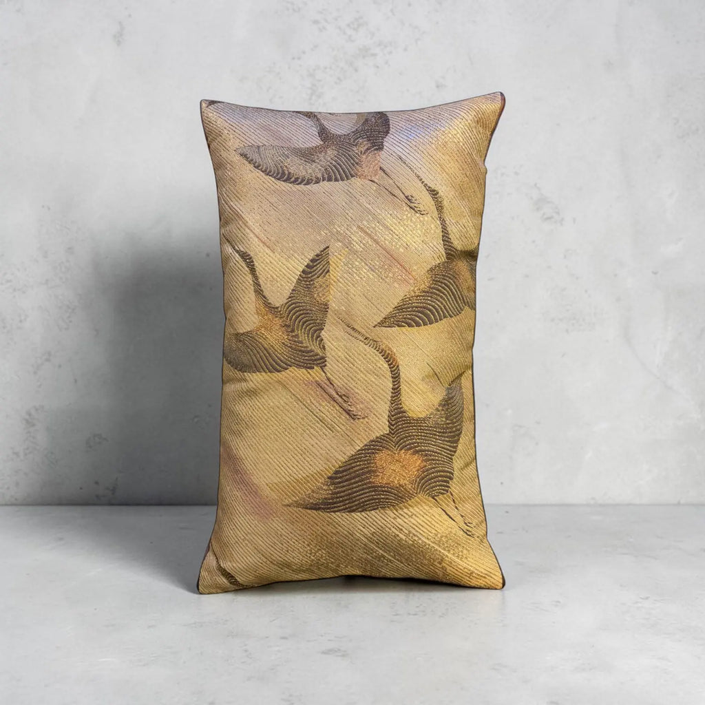 Decorative cushion with crane pattern on a gray background