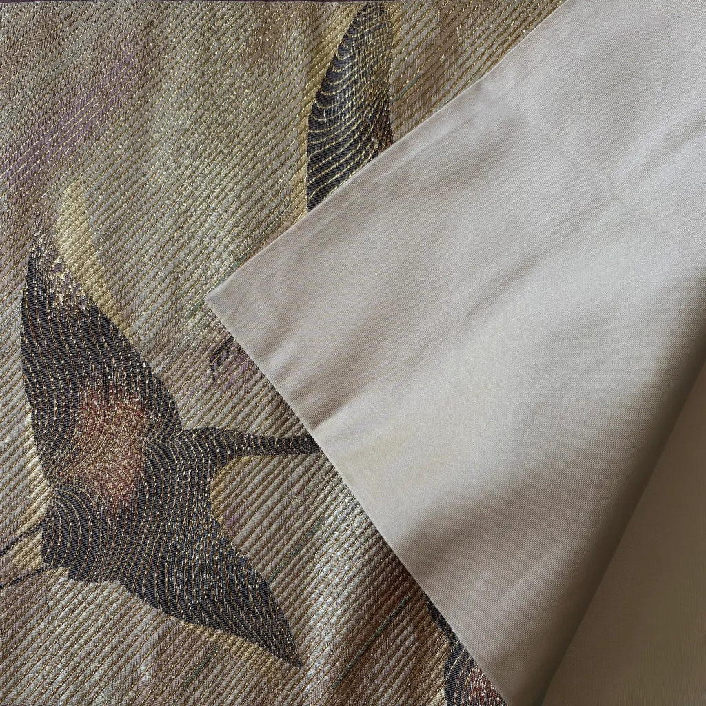 Textured fabric with embroidered design and plain fabric corner